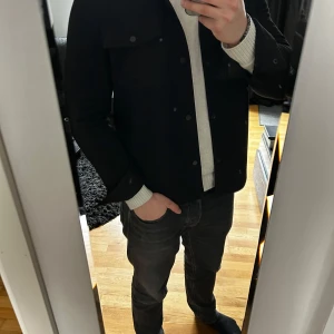 Svart overshirt från Zara - Snygg svart overshirt från Zara med knappar framtill och två bröstfickor. Perfekt nu till varmare väder. Aldrig använd och jätte bekvämt material