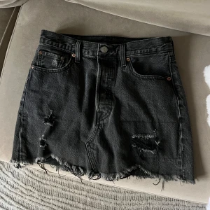 Svart jeanskjol från Levi's - Svart jeanskjol från Levi’s, W26.