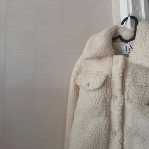 Vit teddyjacka från LA, nakd  - Mysig vit teddyjacka från LA, Linn Ahlborgs kollektion,  med krage och knappar framtill.  
