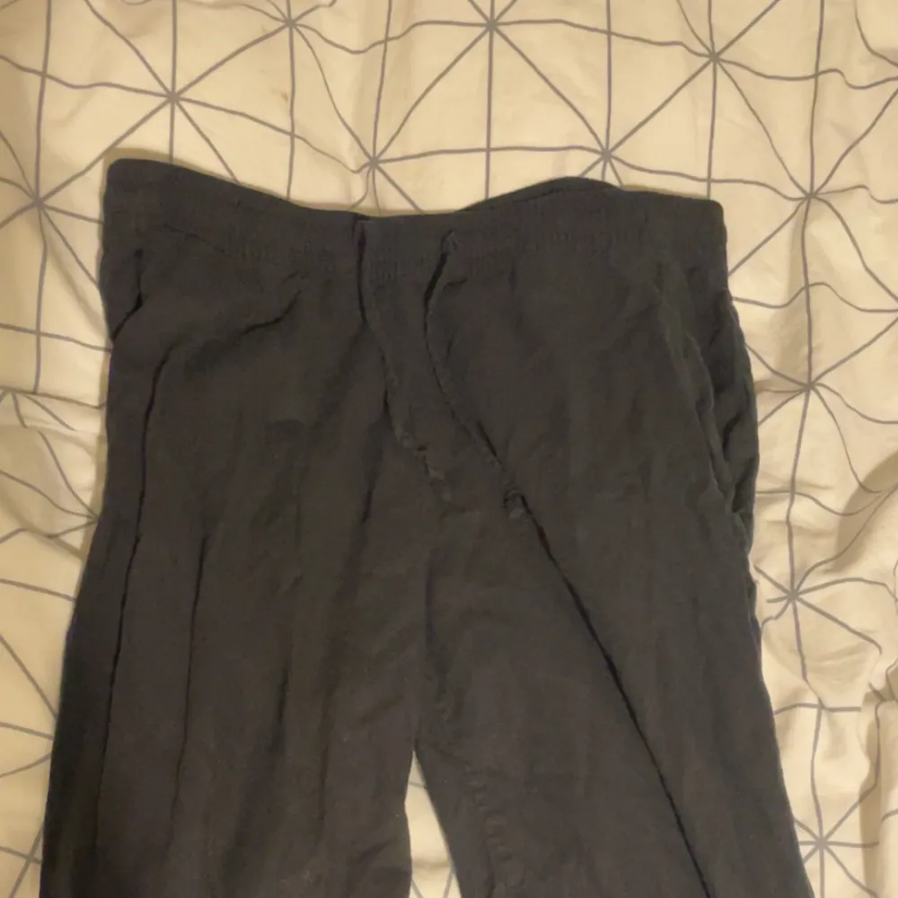 Bekväma svarta linnebyxor med elastisk midja och avslappnad passform. Passar dig som är 160-170cm.. Farkut & Housut.