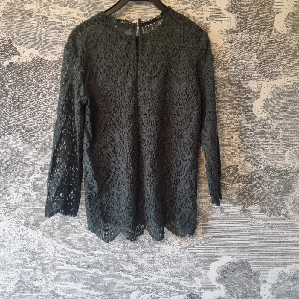 Mörkgrön spetsblus från Zara. Blusen har långa ärmar och ett vackert spetsmönster som ger en stilren look. Blusen är i mycket bra skick. Jag hittar ingenting att anmärka på.. Puserot.