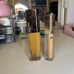 Foundation och concealer från BeautyAct - Säljer en foundation och concealer från BeautyAct. Foundationen är i nyans 12N och concealern i nyans 14N. Båda produkterna har en elegant design med genomskinliga behållare och metalliska lock.