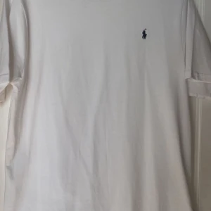 Vit t-shirt från Ralph Lauren - Säljer denna as snygga och populära T-shirten från Polo Ralph Lauren!! Funkar för båda tjejer och killar! Helt ny endast testad! Jag har storlek S i tröjor! Så skulle säga att den är en S/M.Köpt för 595kr!💗