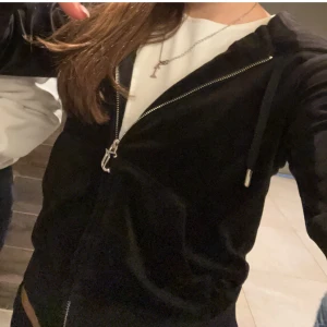 Svart velourjacka med dragkedja juicy couture  - Snygg svart velourjacka med dragkedja framtill. Perfekt för en avslappnad stil. Jackan har långa ärmar och en bekväm passform.