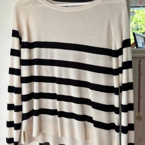 Randig tröja från Zara - Säljer en snygg beige tröja från Zara med svarta/mörk blåa horisontella ränder. Tröjan har rund halsringning, långa ärmar och är i ett tunt, mjukt material som känns skönt mot huden. Perfekt till jeans för en chill look. Kommer inte till användning och är lite för stor så därför säljer jag !🫶🏻