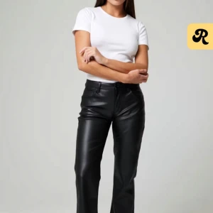 Svarta skinnbyxor - Snygga svarta skinnbyxor med låg midja och raka ben. Byxorna har en klassisk design med fickor bak och bälteshällor. Perfekta för en stilren look. En bit skin har dragits bort men de syns knappast. Nypris 599. Säljer på grund av att de är lite för stora för mig.