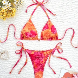 Färgglad blommig bikini - Fin bikini med blommigt mönster i rosa och orange. Helt OANVÄND, råka beställa 2st. I stlk M