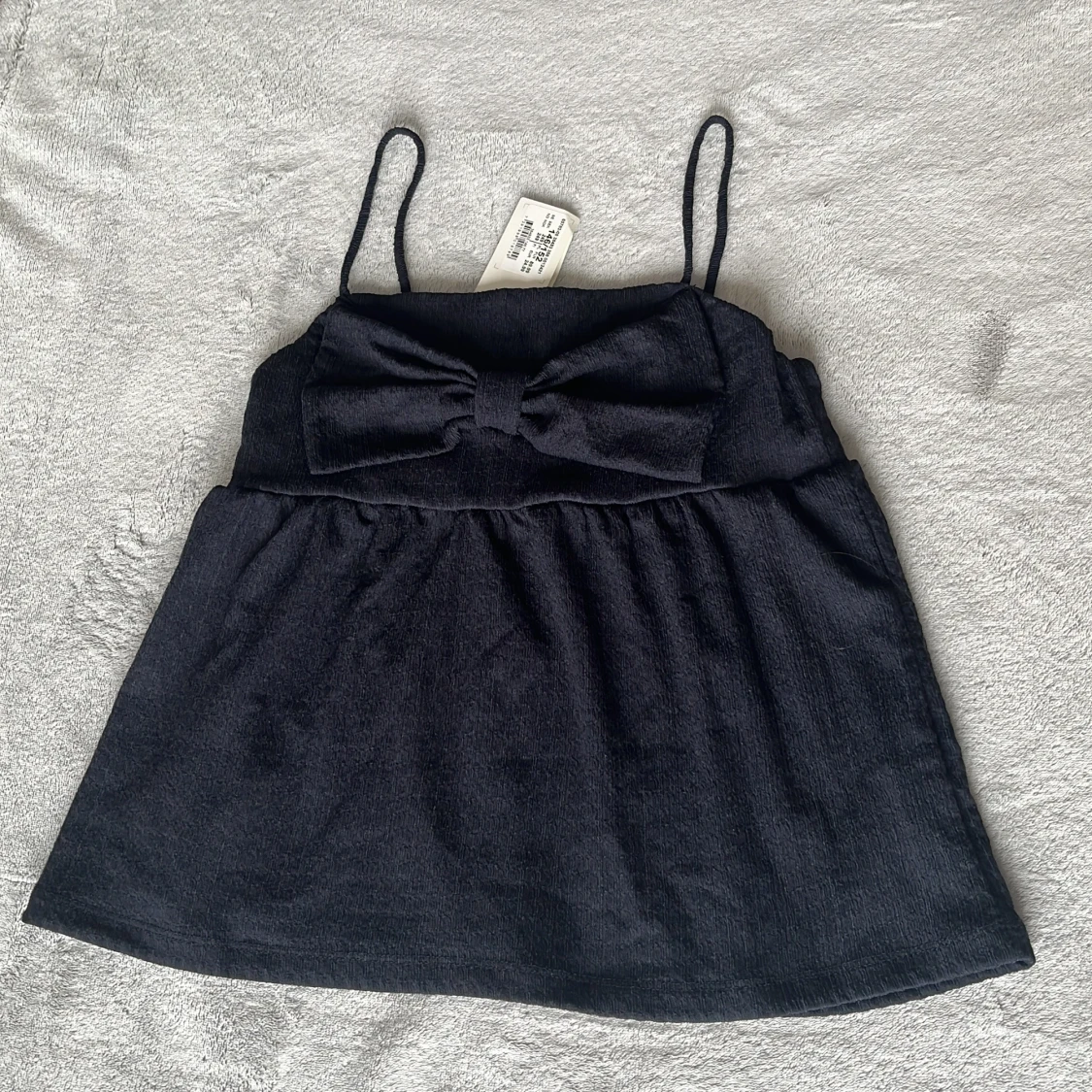 Mörkblå topp med rosett från Kappahl