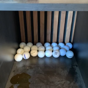 Golfbollar  - Bilderna visar flera golfbollar av olika märken, bland annat Titleist Pro V1, TaylorMade och Callaway Chrome Soft. Ingen bok syns på bilderna, endast sportutrustning. Perfekt för dig som vill förbättra ditt golfspel eller behöver extra bollar till träningen.