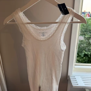 Vit spetskantad linnetopp Brandy Melville - Super sött ribbat linne från brandy, ny med lappar. Ord pris: 200kr🤍 100% bomull