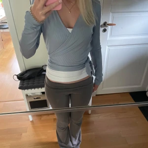 Ljusblå omlottopp med knyt - Supersnygg ljusblå omlottopp med figurnära passform från Bubbleroom