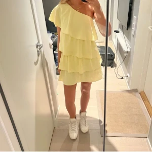 Ljusgul volangklänning med oneshoulder - Superfin ljusgul klänning med volanger och oneshoulder-design, liknar den från zara💕är i storlek 170 men passar XS/S. Prislapp kvar! 