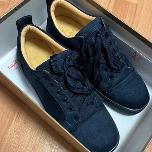 Mörkblå sneakers från Christian Louboutin - Säljer ett par mörkblå sneakers från Christian Louboutin, använda två gånger, Jättebra kvalité, sköna att ha och stiliga.