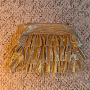 Guldig volangkjol - Midjemåttet är 38 cm men det är mycket stretchigt material. 