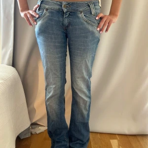 Blå bootcut jeans från Lee - Snygga blå jeans från Lee med bootcut passform och låg midja. 