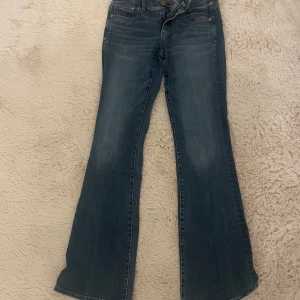 Blå bootcut jeans från American Eagle - Jättesnygga jeans från amerikan Eagle som aldrig är använda. Köpta i Paris i år men aldrig kommit till användning💕💕skriv för frågor även pris kan diskuteras💗💗är ca 163.7