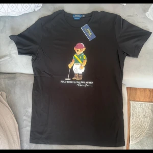 Svart Polo Bear t-shirt från Ralph Lauren - Svart Ralph Lauren T-shirt med nallebjörn tryck 🐎 👕  Storlek S✅  Helt ny 🆕   Pris går att diskutera 🤝 Går att köpa upp till 5 stycken! Hör av er vid frågor eller fler bilder :)