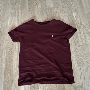 Vinröd t-shirt från Polo Ralph Lauren - Vinröd t-shirt från Polo Ralph Lauren. T-shirten är gjord i mjuk bomull. Storlek S och pris kan diskuteras
