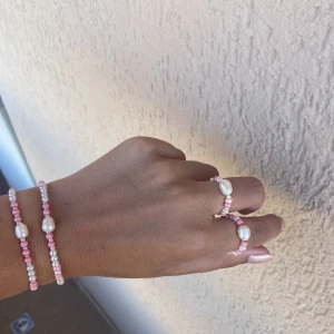 1 rosa ring samt 1 rosa armband  - En färgstark kombination med sötvattenspärla i mitten. 