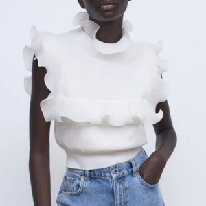 Vit stickad topp - Vit stickad topp med volanger från Zara i storlek S. Använd endast 1 gång och är normal i storlek. 