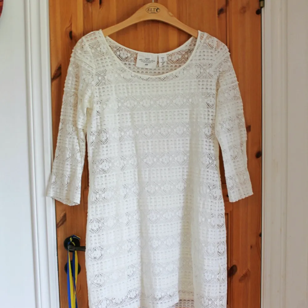 En jättefin vit klänning med spetstyg och silkeslen innerklänning. Passar perfekt under sommaren eller till studenten och skolavslutningar.   Märke: H&M Storlek: 38. Klänningar.