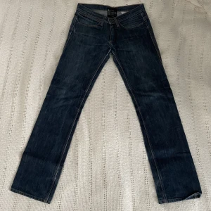 lågmidjade acne jeans - Lågmidjade bootcut jeans ifrån acne! Köpte jeansen på loppis, dom har ett litet hål i skrevet som enkelt går att laga och dom saknar delen man drar upp dragkedjan med. Annars är jeansen i fint skick! Midja rakt över 36cm, innerbens längd 80cm❣️