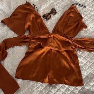 Bronze color forever21 romper/ jumpsuit. One piece. Shorts. With zipper and button. Very flattering ties at the waist for hourglass shape. Very good condition 