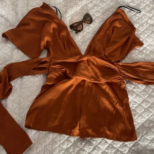 Classy romper  - Bronze color forever21 romper/ jumpsuit. One piece. Shorts. With zipper and button. Very flattering ties at the waist for hourglass shape. Very good condition 