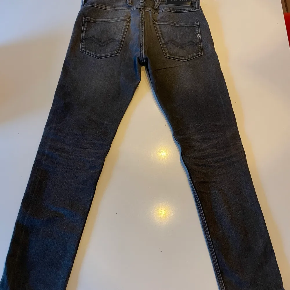Ett par svarta replay jeans. Jeansen har ett hål på varje ben nere vid hälen. De går absolut att använda men de är lite slitna.. Jeans & Byxor.