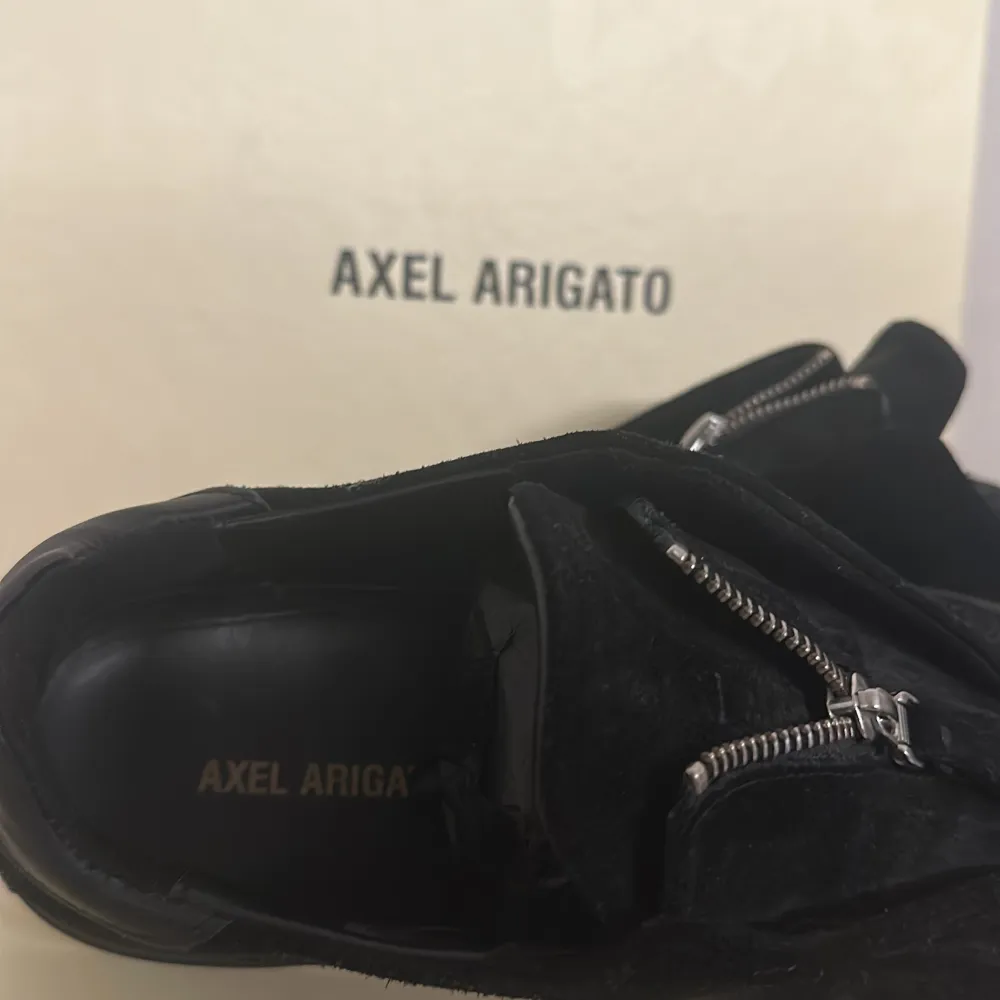 Märke: Axel Arigato Modell: Clean 90 Zip Storlek: 43 Condition: 8/10  Otroligt sparsamt använda skor, inga scuffed eller creases, lätt slitning på zip taben men annars så gott som nya!  Säljs då dom är för stora för mig. . Skor.