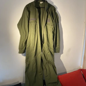 Military overall, vintage, XL - Green overall, perfect to match with a belt for a unique style. Zippers on the side. Bought in a vintage market in Amsterdam. Size XL