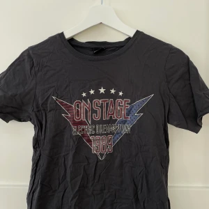 T-shirt med rockigt tryxk  - Grå t-shirt med rockigt tryck