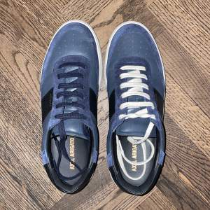 Helt nya Axel arigato skor i en marinblå färgkombination.  Köpa för 2800 Endast använda 3 gånger.  Medföljer både vita och marinblåa skosnören.  Kvitto finns.