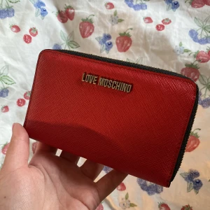 Love Moschino Plånbok - Säljer mig plånbok från märket Love Moschino. Köpt från zalando för ett par år sedan för 1200kr. Sparsamt använd, har inge yttre eller inre fel eller märken💗 skriv om ni vill ha fler bilder! Priset är diskuterbart!