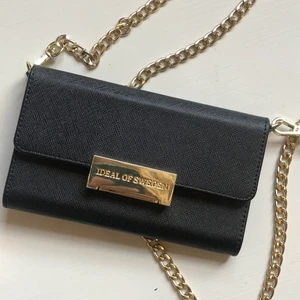 Väska - Jättefin och praktisk, svart väska från Ideal Of Sweden. 📸🖤 Jag köpte den för 500 kr och som ni ser på bild två, kan man stoppa sina kort i väskan, och ena sidan är magnetisk. Där kan man sätta sin telefon om den är magnetisk, vilket bla alla skal från Ideal Of Sweden är. (Jag säljer just nu 2 st sådana skal, så kolla gärna in dem!) 