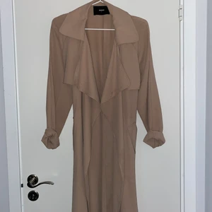 Beige lång kappa  - En beige lång kappa från Bik Bok storlek S.använd ett fåtal gånger mycket fint skick 