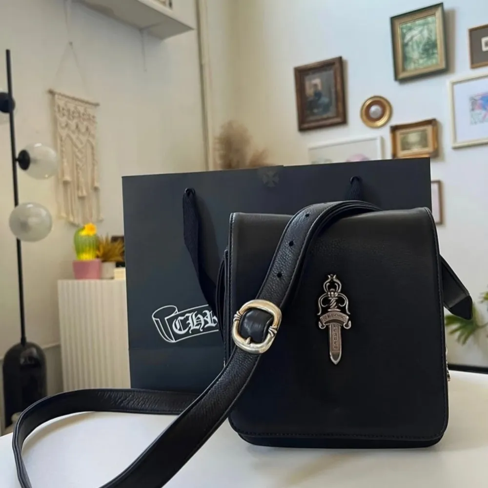 CH ending bag production so purchase while available!  Comes with original packaging & receipt  Black Calf leather  Two interior slots, one zipper pouch  Sick .925 Silver Dagger pendant  Adjustable strap  Purchased 2021 at the wynn in las vegas. Väskor.