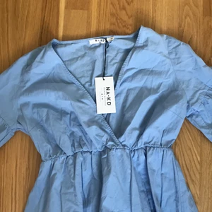 Klänning - En såååå fin klänning i ljusblått! Jättehärligt till sommaren, köpte den förra sommaren men den är aldrig använd och prislappen är kvar! Nypris 200kr, köparen betalar frakt :)