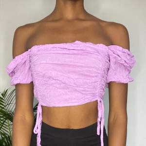 Super cute velvet purple crop top with adjustable drawstring. The material is a bit thin but still covers everything. Fits very nicely and comfortably. 