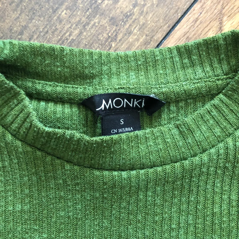 Croppad grön t-shirt från Monki med cut-out på axlarna. Skön med bra passform. Säljes endast för att jag inte använder den längre.. T-shirts.