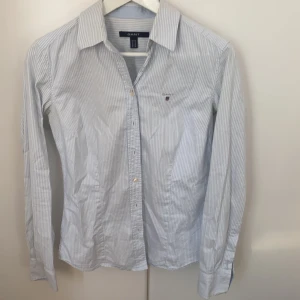 Gantskjorta med blå och vit randigt mönster  - En gantskjota köpt för längesen som inte kommer till användning längre 