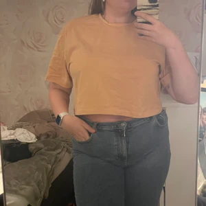 Vintageinspirerad orange t-shirt  - En lite croppad orange t-shirt med ett mörkt ”Harmony”-tryck! Superskön att ha på sig, tunnt tyg som andas bra! Använd 1-3 gånger🧡 