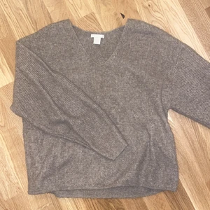 Stickad tröja - Mysig stickad tröja i mörkare beige färg. V-urringning. Storlek S. 