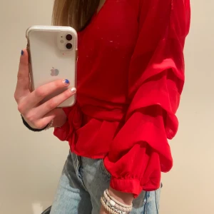 Röd blus från NAKD - Så snygg blus från NAKD med snören som man knyter till en rosett🤍aldrig använt💕den första bilden är en liknande från samma märke!
