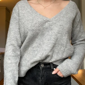 Grå stickad tröja med v-hals - Stickad lite oversized tröja med v-hals från Vila. Strl M. Endast använd ett fåtal gånger. Nyskick. 