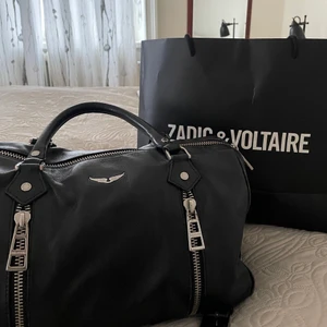 sunny bag big - Säljer min svarta zadig väska i modellen sunny bag. Är den största modellen och således perfekt till skolan, böcker tillsammans med gympakläder får plats👌 köptes på zadig butiken för 3 år sedan så lite sliten men välfungerande, kan skicka bilder på de slitna om så önskas men bilderna visar en bra helhets bild. Kan ha kvitto, box, dustbag osånt kvar men är osäker ( kan leta om nån vill) ❤️ ÄKTA KOLÄDER