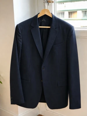 Mörkblå HOPE kostym – Grant Blazer & byxa (svart/navy) kavaj med klassisk passform - Stilren och tidlös kostym från HOPE. Klassisk kavaj i modellen Grant Blazer. Använd vid enstaka tillfällen, i mycket fint skick. Nypris 4000 kr