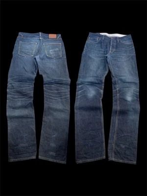 Japanese archive selvedge denim - NOT MOMOTARO. Selling a pair of high quality japanese raw denim from Hiut Denim Co.  New price ≈ 300€ Perfect fit and very good condition Jeans feature stylish factory repairs that have been professionally made in the Hiut store. They are unnoticable in wear. Beautiful color and unique detailing  Great add to your closet 👌 Fast shipping 📦 Measurments: Full length 116cm Waist 43.5cm Leg opening 19.5cm  Keywords   American vintage, Vtg, thrifted, Retro, Y2k, 2000s,, School, grisch, Archive