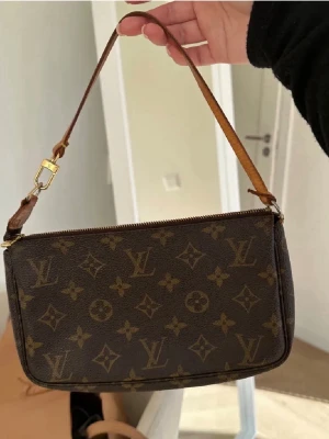 Louis Vuitton Pochette bag - Intressekoll på min fina Louis Vuitton Pochette väska. Köptes sommaren 2023 av @sncvintage, finns äkthetsbevis genom dem som skickas vid köp. Förra sommren bytte jag ut läderbiten som började bli gammal, så nu är den ny och fräsch (och därmed inte original läderbiten)🤍