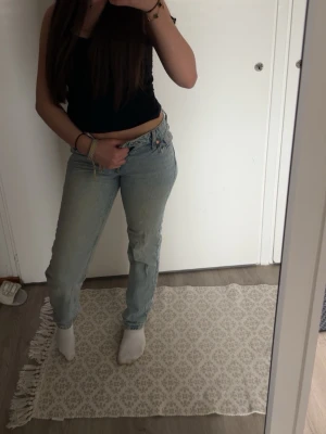 Ljusblå raka jeans från & Denim  - Säljer ett par klassiska ljusblå jeans från Levi's med rak passform och hög midja. Jeansen har fem fickor, knappgylf och är tillverkade i denim. Perfekta för en avslappnad och trendig look. Säljer då de är for små för mig 💞Har en liten brun fläck som visas på bild 3.